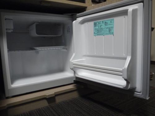 an empty refrigerator with its door open in a kitchen at Hotel Route-Inn Mihara Ekimae in Mihara