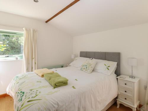 a bedroom with a large white bed with a window at Lakeside Lodge in East Harling