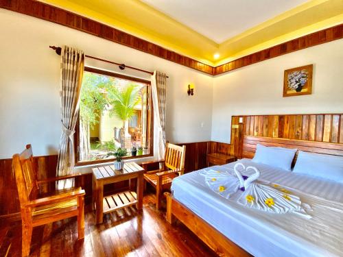 a bedroom with a large bed and a window at Villa Lien Tho in Phú Quốc