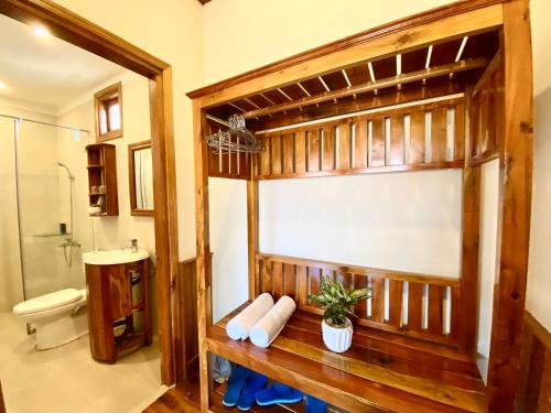 a bathroom with a bench with a shower and a toilet at Villa Lien Tho in Phú Quốc