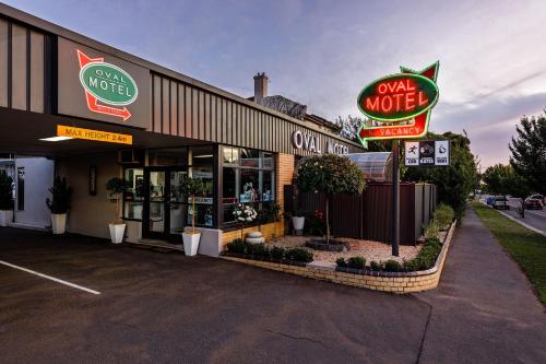 a store front of a motel with neon signs at Bendigo Oval Motel in Bendigo