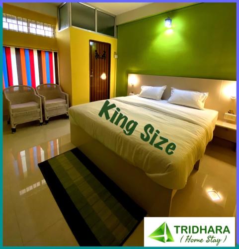 a bedroom with a king size bed in a room at Tridhara HomeStay in Guwahati