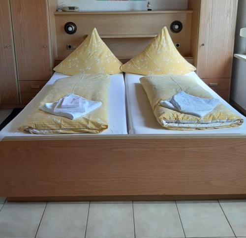 a bed with two blankets and pillows on it at Mosel Panorama in Zell an der Mosel