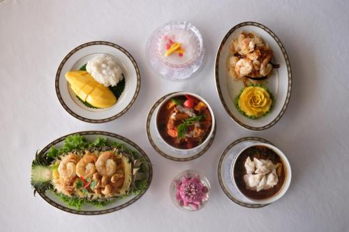 a group of plates of food on a table at Methavalai Residence Hotel in Bangkok