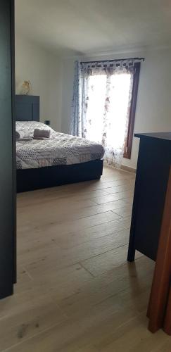 a bedroom with a bed and a window at Appartamento Alissya in Tortolì