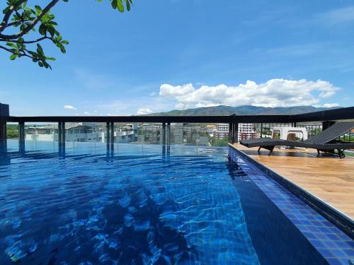 a swimming pool on the roof of a building at Modern loft room& Rooftop pool at Nimman 603NM in Chiang Mai