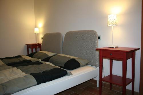 a bedroom with a bed and a table with a lamp at Appartamenti Urbevetus in Orvieto