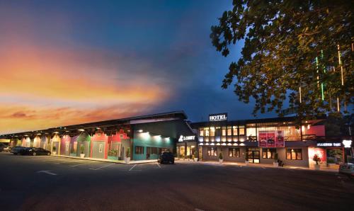 a store front with lights on at night at THE WOOD BOUTIQUE HOTEL in Muar