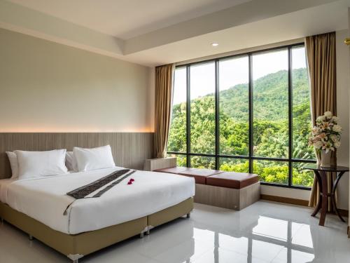 A bed or beds in a room at Ozone Hotel Khao Yai