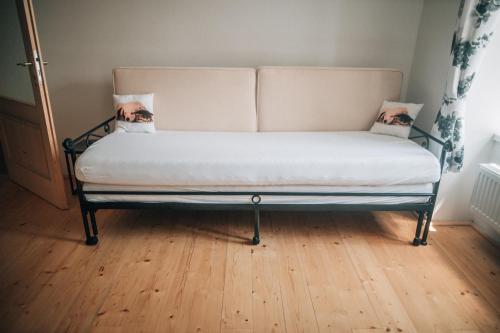 uma cama sentada num piso de madeira num quarto em Apartmán v přírodě v srdci Vysočiny 1 em Jihlava