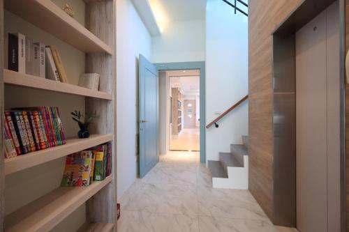 a hallway of a house with bookshelves at Manting Homestay in Hualien City