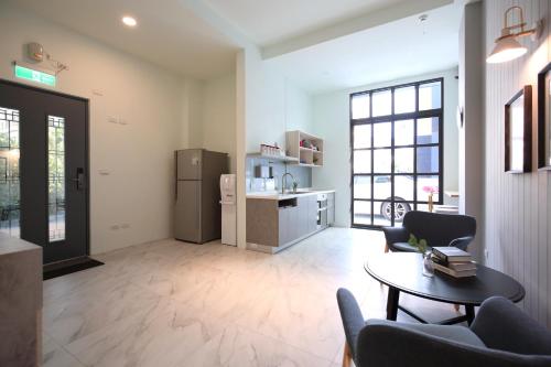 a living room with a refrigerator and a table at Manting Homestay in Hualien City