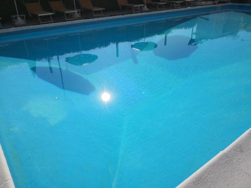 a swimming pool with a light in the water at Park Hotel in Rimini