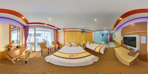 a large room with a large bed and a television at Hoa Dao Hotel in Hòa Bình