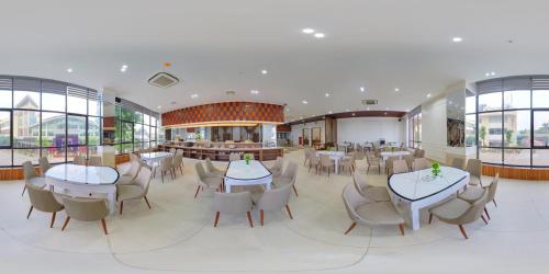 a restaurant with tables and chairs in a building at Hoa Dao Hotel in Hòa Bình