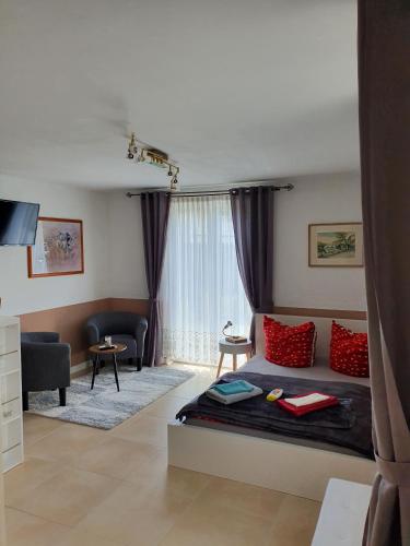 a bedroom with a bed and a living room at Haus Marianne in Weilheim