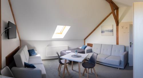 a living room with a couch and a table at Pod Sową in Sokolec