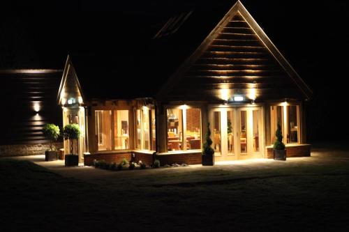 a house lit up at night with lights at Ivy House Country Hotel in Lowestoft