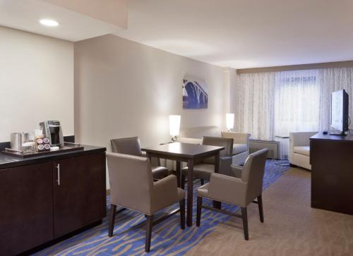 a hotel room with a dining room table and chairs at Holiday Inn Washington Capitol-National Mall by IHG in Washington