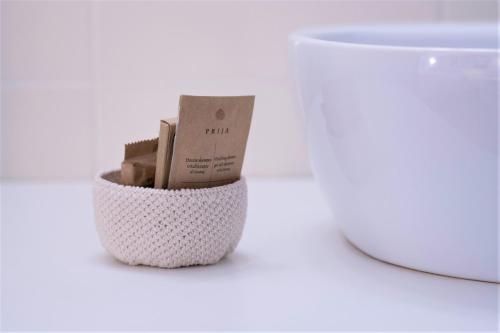 a white crochet container with a box in it at Zia Pupetta Suites in Amalfi