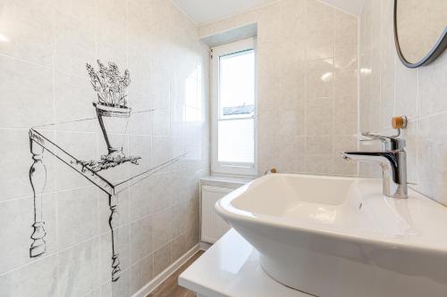 a white bathroom with a sink and a mirror at Morze u Moni in Karwieńskie Błoto Pierwsze