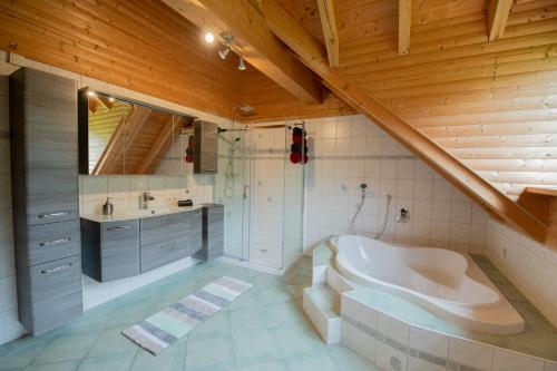 a large bathroom with a tub and a sink at Betzemühle 1 Bauernhof in Altenschlirf