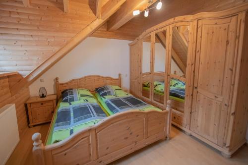 a bedroom in a log cabin with a bed at Betzemühle 1 Bauernhof in Altenschlirf