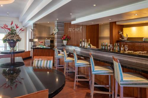 a restaurant with a bar with chairs and a counter at City Lodge Hotel Durban in Durban