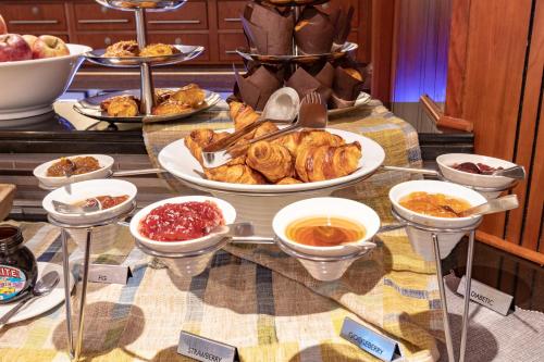 a table topped with plates of pastries and other foods at City Lodge Hotel Durban in Durban