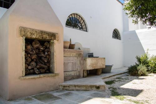 a fireplace with a pile of wood in it at Palazzo Castriota in Alezio