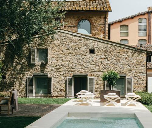 a large stone building with a pool of water in front of it at Riva Lofts Florence in Florence