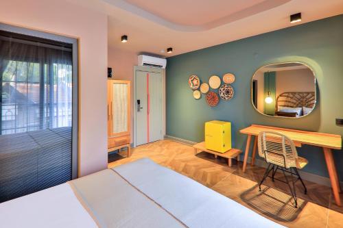 a bedroom with a table and a mirror at Luff Boutique Hotel - Adult Only in Kas