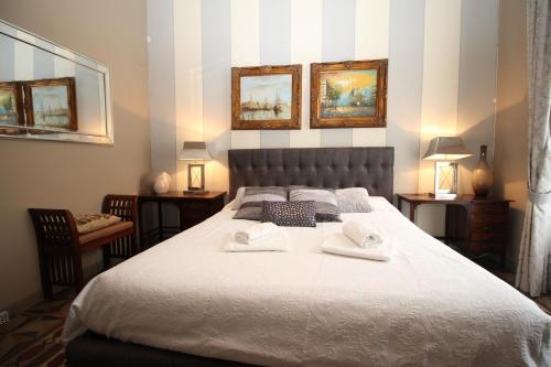 a bedroom with a large bed with two towels on it at The Lake Como Villa in Menaggio
