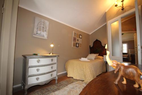 a bedroom with a bed and a dresser with a dog in it at The Lake Como Villa in Menaggio