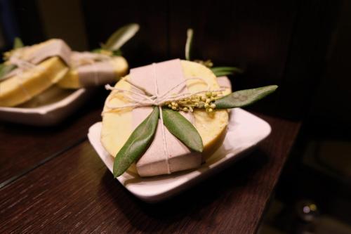 a cake sitting on a plate on a table at Il Miglio in Più in Castel di Tusa
