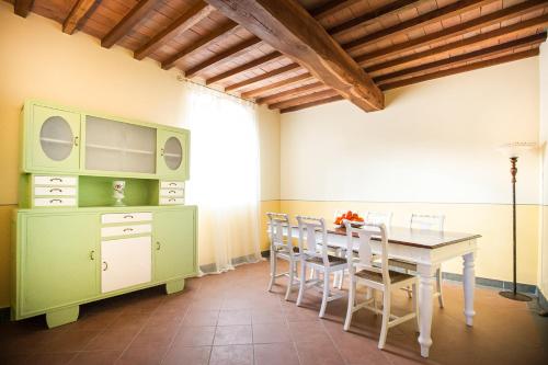 a dining room with a table and chairs at Fattoria Le Fonti in Poggibonsi