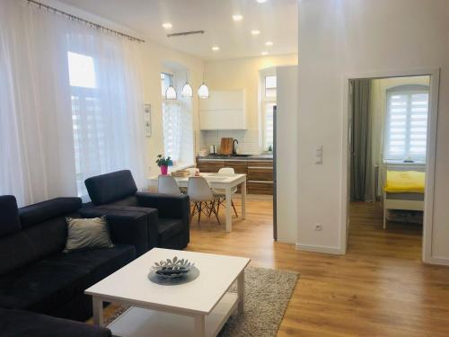 a living room with a couch and a table at Apartament Sasanka in Kowary