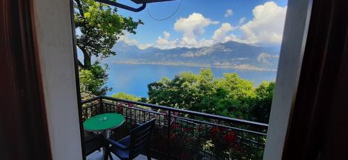 a balcony with a view of a lake and mountains at Albergo Alle Fasse in Brenzone sul Garda