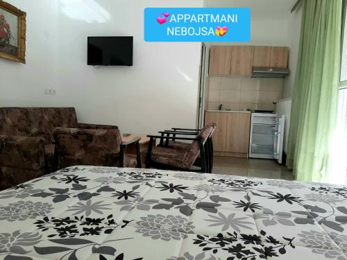 a living room with a bed and a kitchen at Apartments Nebojša in Soko Banja