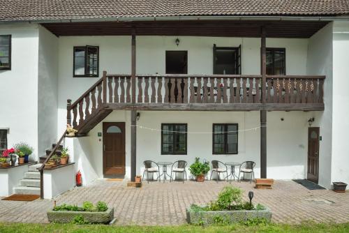 a house with a deck and chairs in the courtyard at Penzion Marcipánka in Třeboň