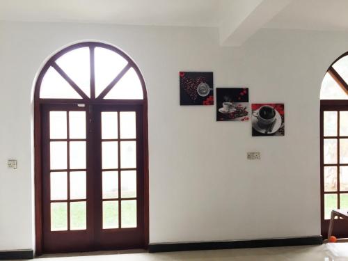an open door in a room with two windows at Grand Villa Negombo in Negombo