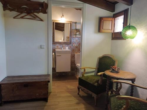 een woonkamer met een tafel en stoelen en een keuken bij Mas Gibert in Sant Gregori