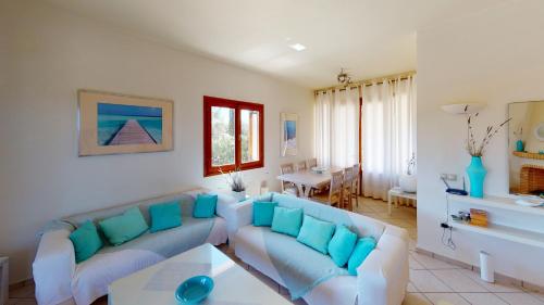 a living room with a couch and a table at VILLA EVANTHIA in Bouzéïka