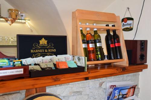 a shelf with wine bottles on top of a fireplace at Penzión Príjemný Oddych in Banská Štiavnica