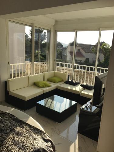 d'un salon avec un canapé et une télévision sur un balcon. dans l'établissement Naturiste Cap d'Agde Natura Beach 111, au Cap d'Agde