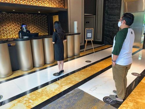 a man and a woman wearing a mask in a bowling alley at The Alts Hotel in Palembang