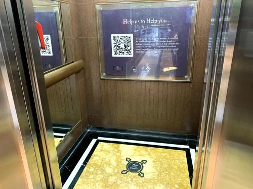 an elevator with a floor with a crab on it at The Alts Hotel in Palembang