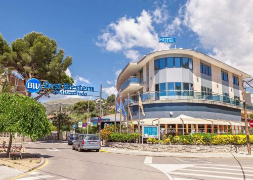 a hotel with a car parked in front of it at Best Western Hotel Mediterraneo in Castelldefels