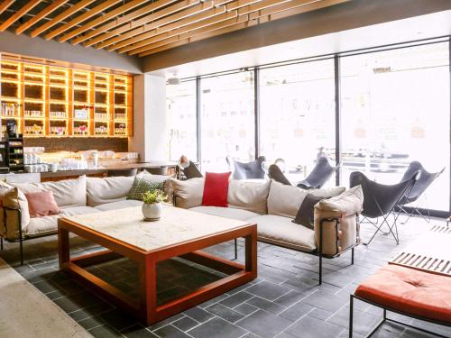 a living room with couches and a table at ibis Osaka Umeda in Osaka