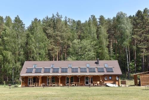 a large house with solar panels on the roof at Duriu sodyba in Molėtai